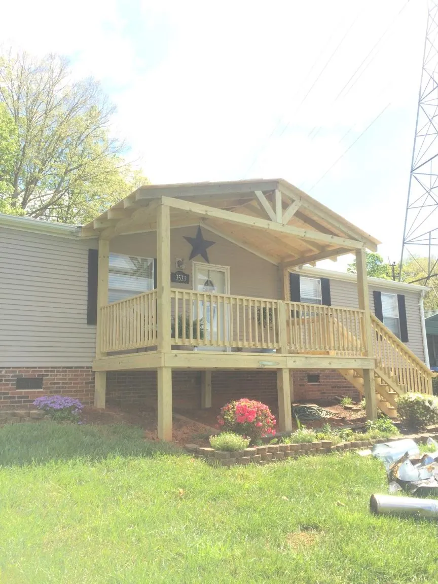 New gabled porch roof and deck railing added to a ranch home in Orange Park